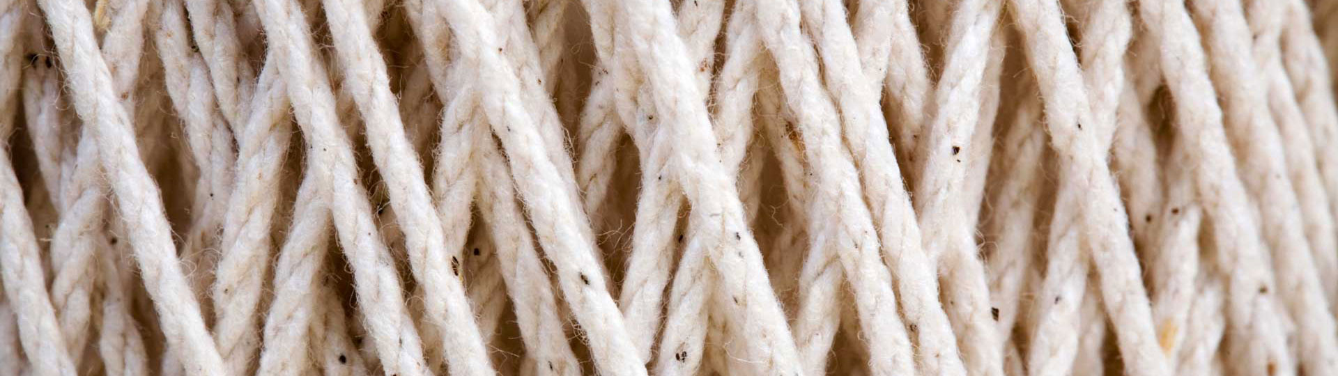 Cream colored cotton yarn in criss-crossed pattern