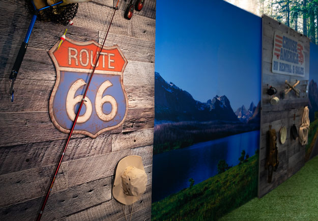 A route 66 sign attached to a reclaimed wood wall